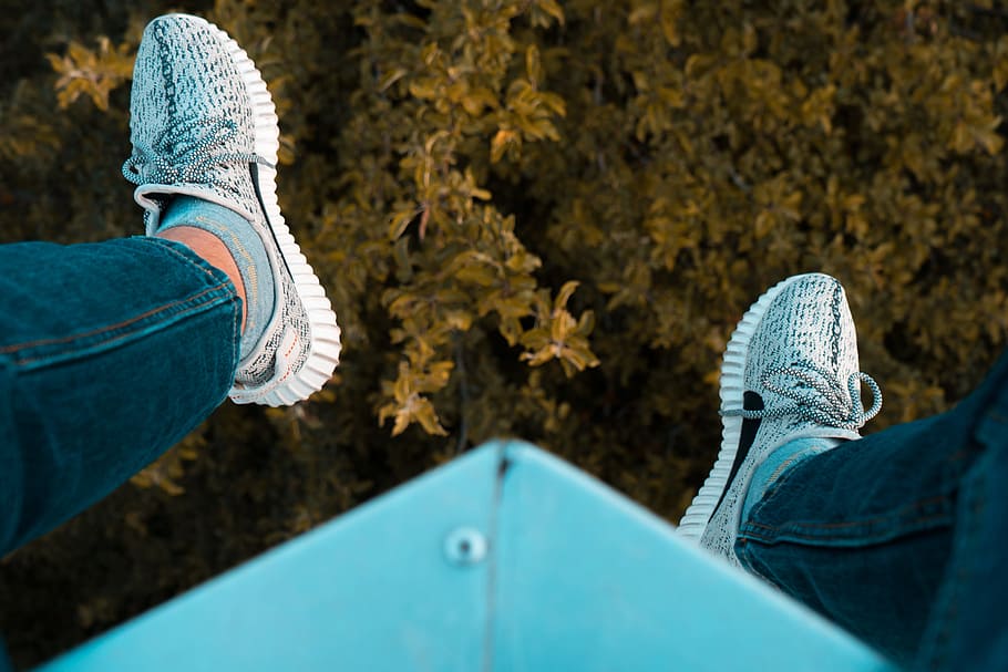 person wearing white adidas sneakers sitting on blue steel frame, person wearing sneakers sitting on edge, HD wallpaper