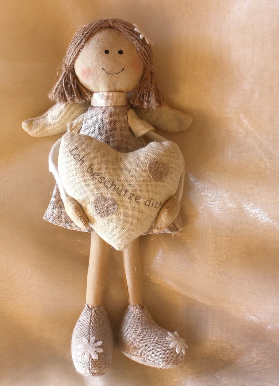 female angel holding heart rag doll on brown textile, figure, HD wallpaper