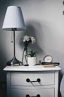 gray metal base white lampshade on nightstand, closeup photo of white petaled flowers in vase beside table lamp HD wallpaper