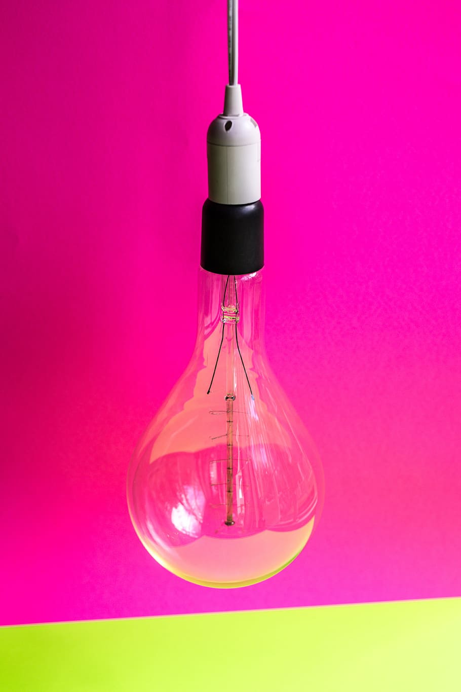 close-up photo of light bulb with pink background, clear glass halogen light bulb HD wallpaper