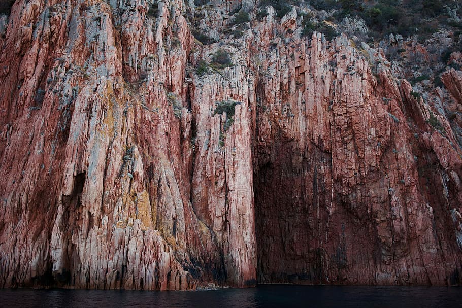 brown mountain cliff, brown rock mountain on body of water, sea HD wallpaper