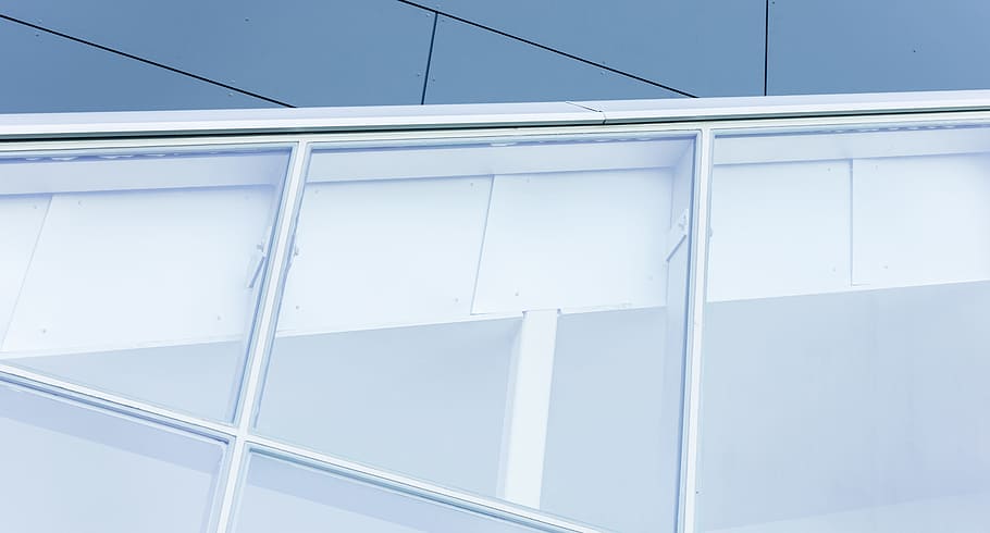 A close view of a building with dark exterior and large, white-framed white windows cutting across at an angle, untitled HD wallpaper