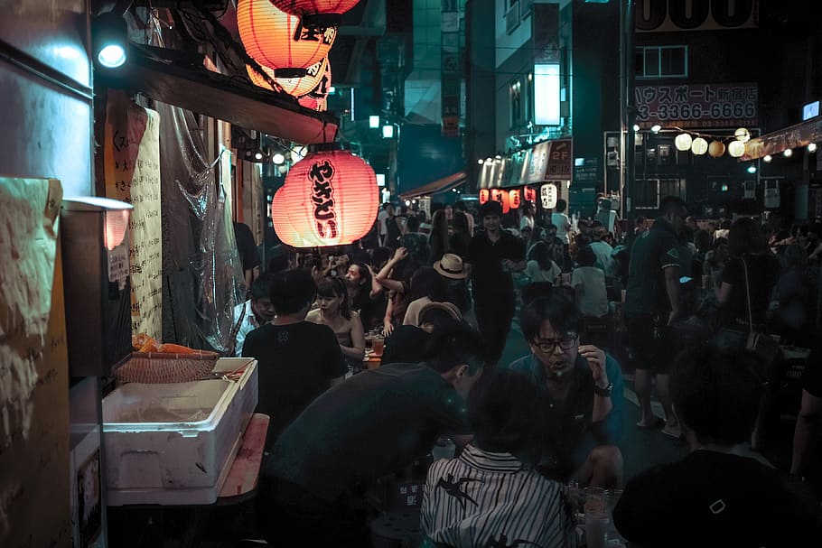 photo of people gathering in market during nighttime, group of people on street