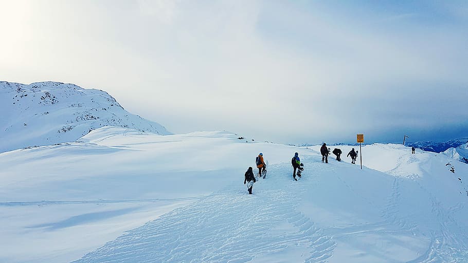 people walking on snow mountain, people walking on snow under white clouds HD wallpaper