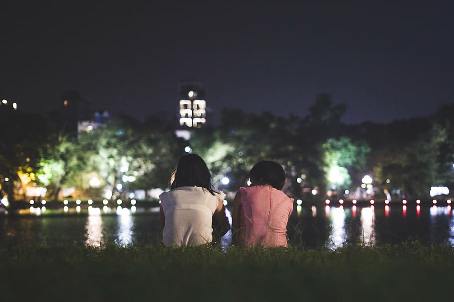 two woman seats on green grass at nighttime, hanoi, vietnam, people, HD wallpaper