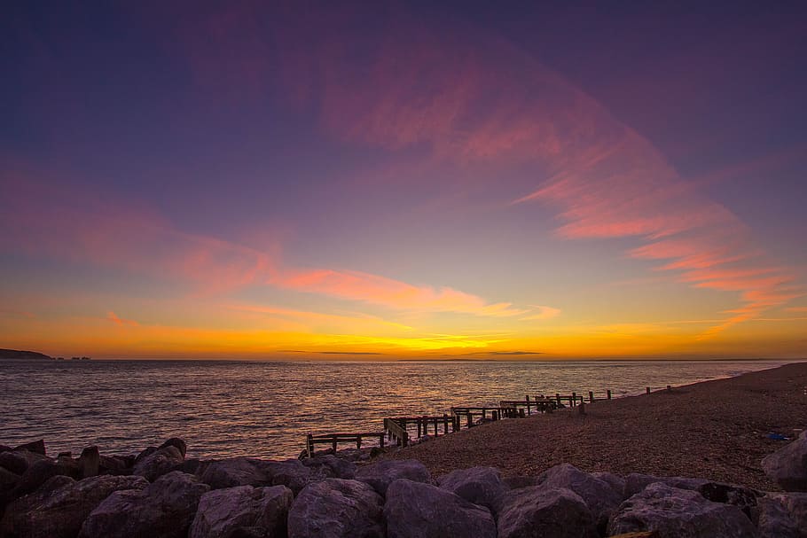 rocks near sea during golden hour, beach, ocean, key haven HD wallpaper