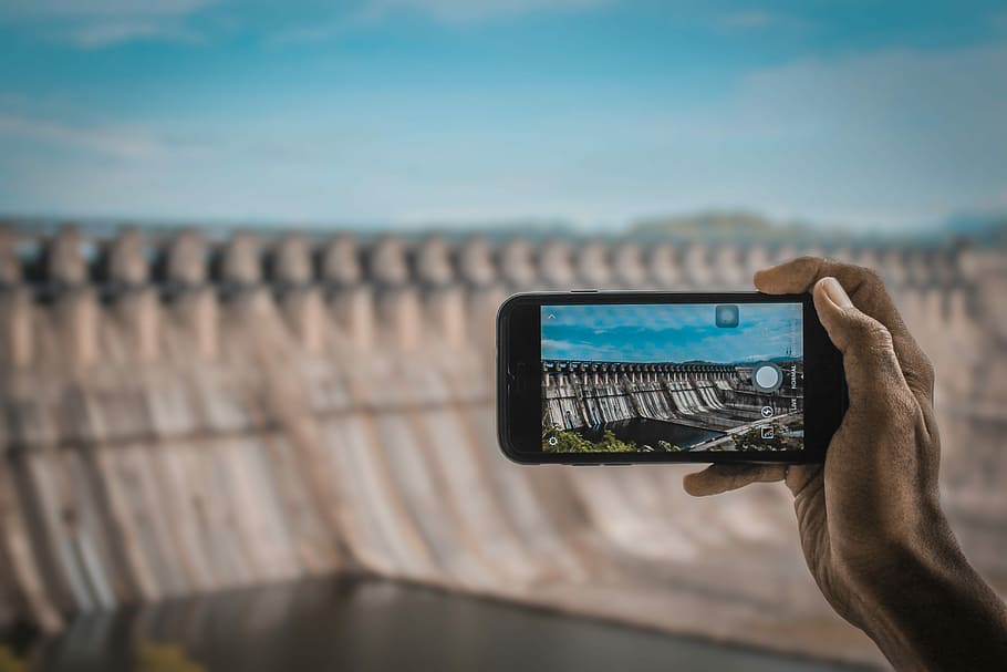 person taking a photo of dam, camera, phone, hand, holding HD wallpaper