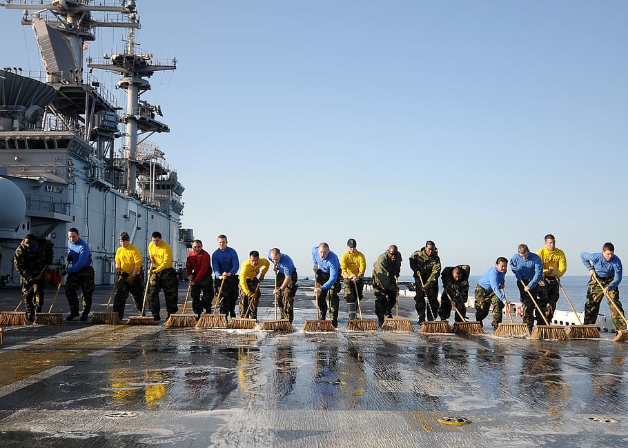 people cleaning flight deck of an aircraft carrier, teamwork