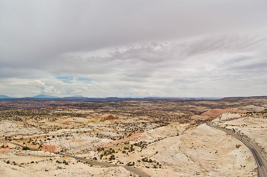 aerial shot of dried land under cloudy sky, vast valley during daytime HD wallpaper