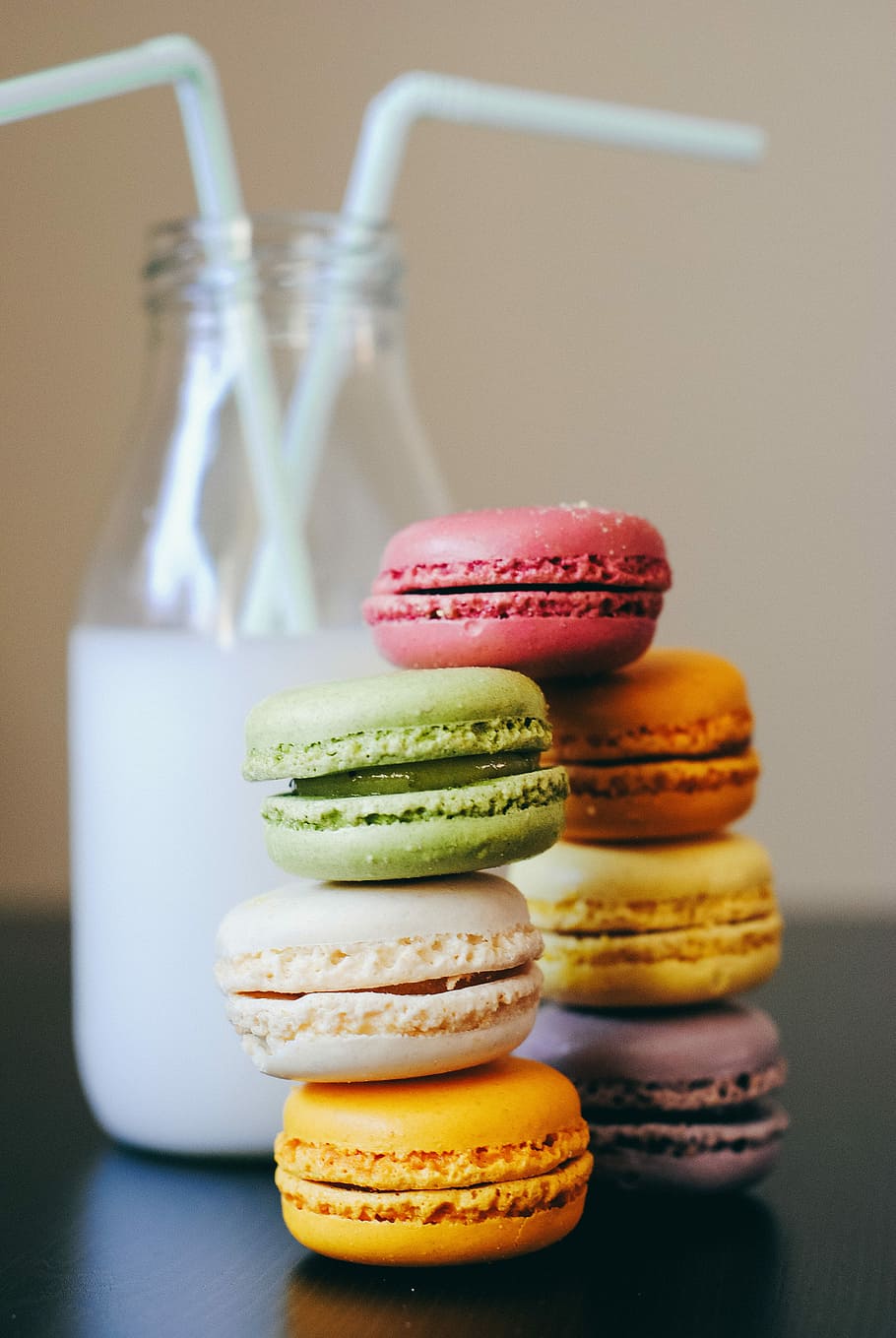 piled macaroons, seven assorted-color French macaroons beside bottle of milk drink, HD wallpaper