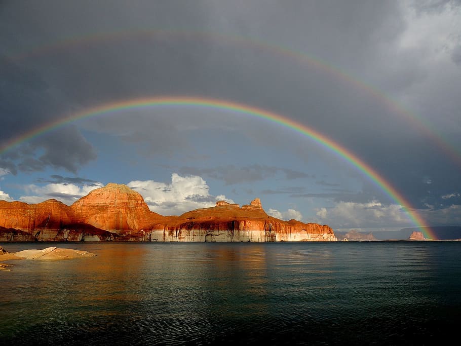 rocky mountain beside sea at daytime, rainbow, lake powell, padre bay