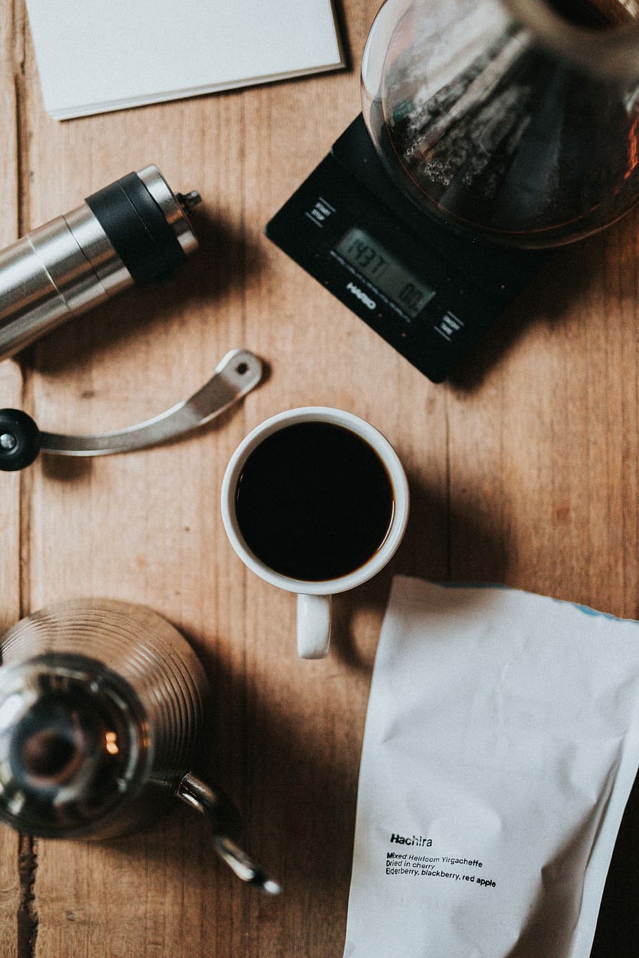 cup of black coffee beside stainless steel teapot, cup of coffee beside coffeemaker and white paper HD wallpaper