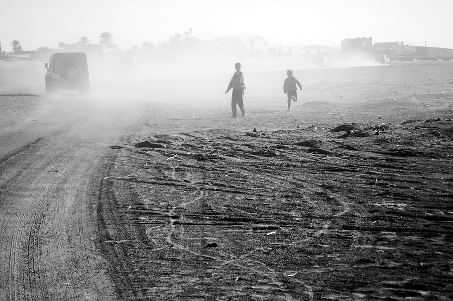 two children's standing on sand, morocco, africa, rally, desert