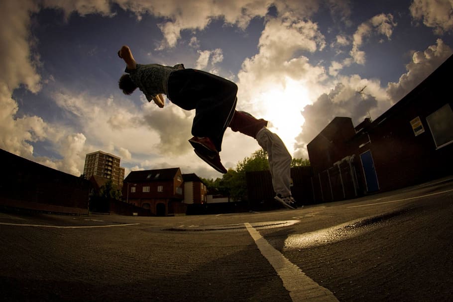 man on mid air beside building, back flip, double, jump, sport, HD wallpaper