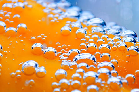 close photography of orange liquid, backgrounds, yellow, blue HD wallpaper