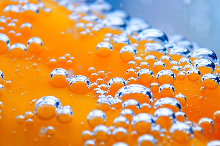close photography of orange liquid, backgrounds, yellow, blue