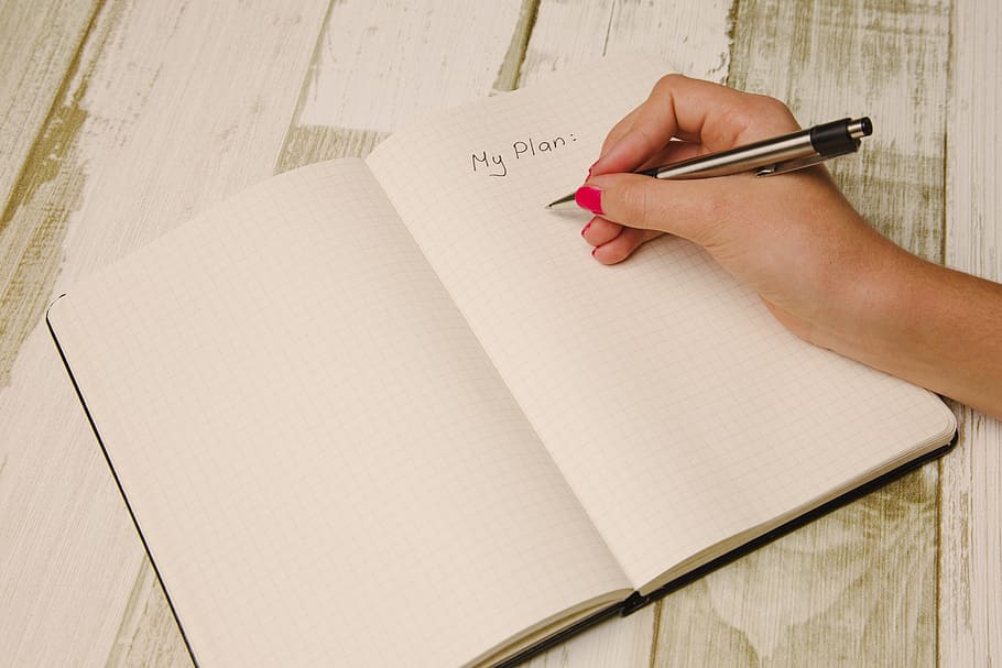 person holding silver and black pen, arm, hand, desk, notebook HD wallpaper