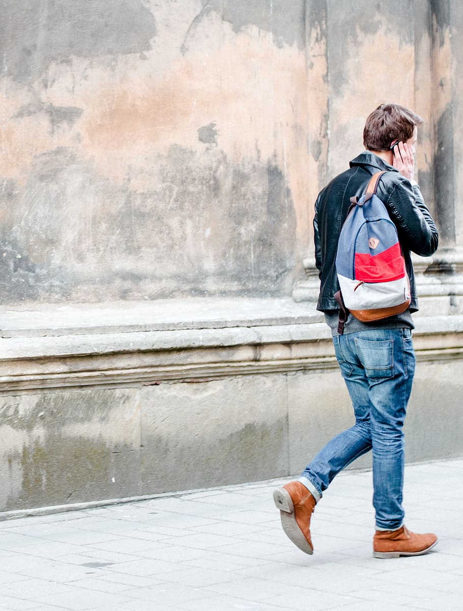 man in black jacket using smartphone, people, guy, walking HD wallpaper