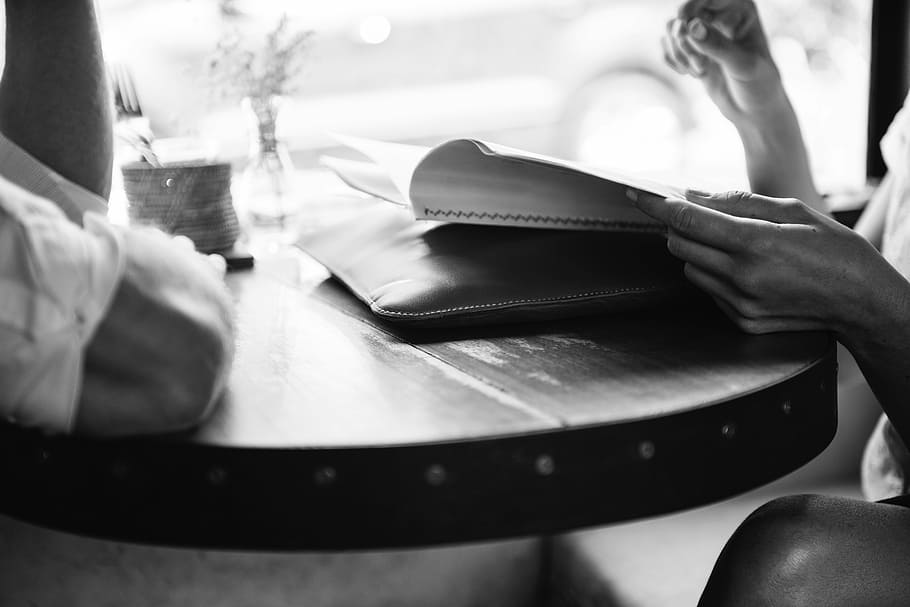 person reading book, people, restaurant, table, menu, order HD wallpaper
