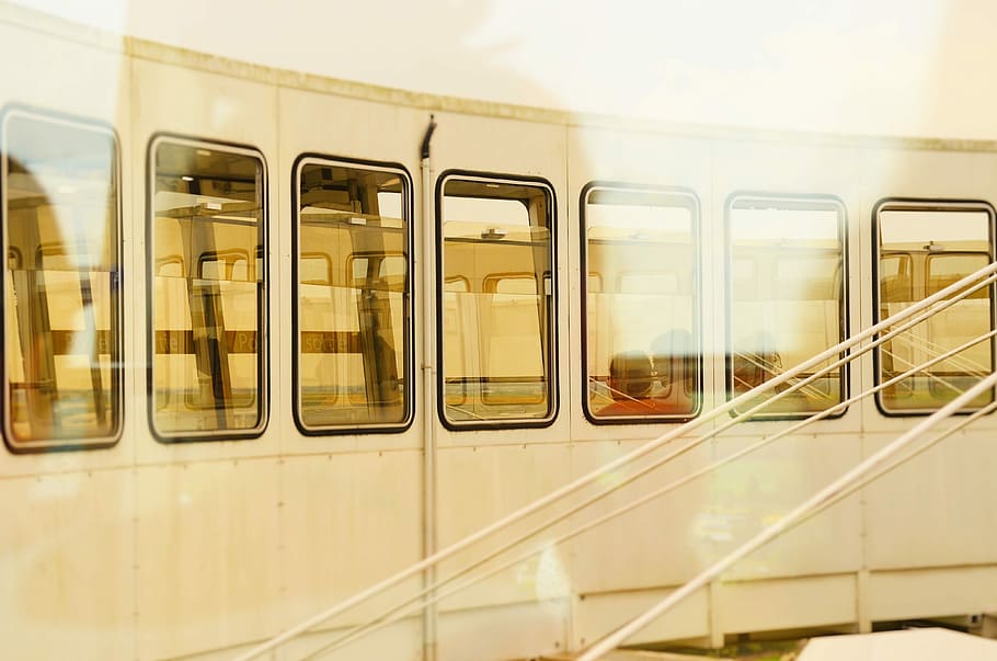 closeup photo of white train, person inside white train at daytime HD wallpaper