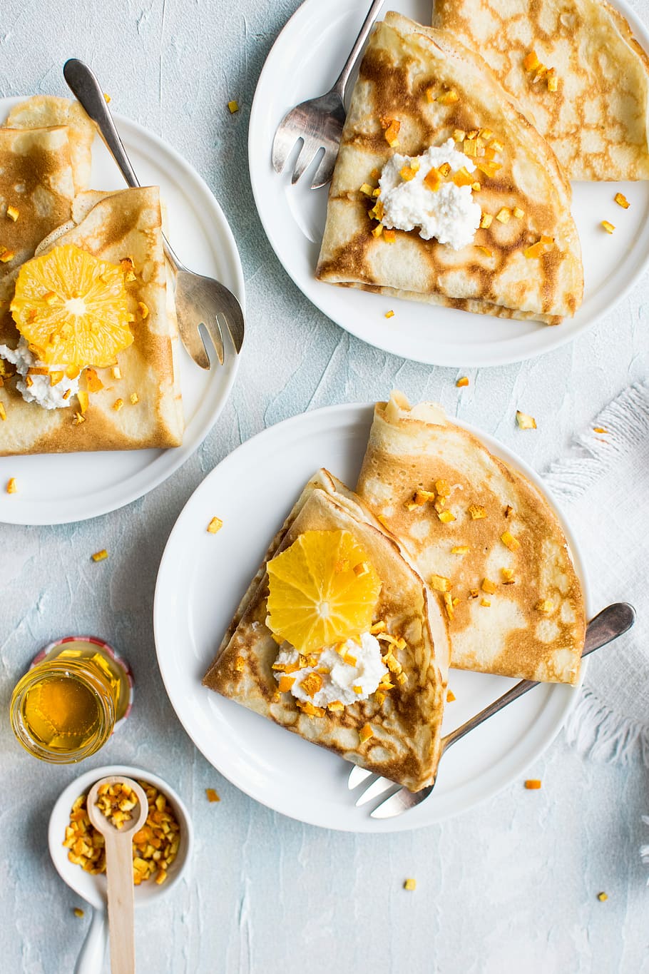flat-lay photography of pancake with icing, baked roti breads on white ceramic plates HD wallpaper
