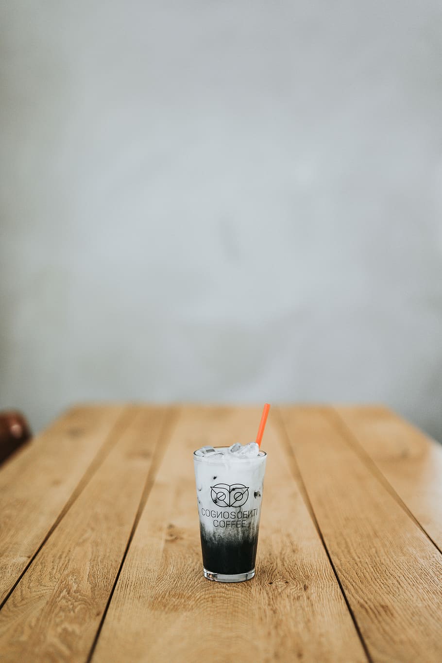clear glass drinking glass with liquid inside on wooden table, ice and beverage filled drinking glass with straw on wooden table HD wallpaper