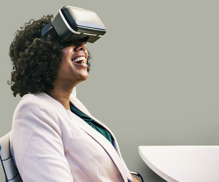 woman wearing VR goggles, headset, african american, fun, happy