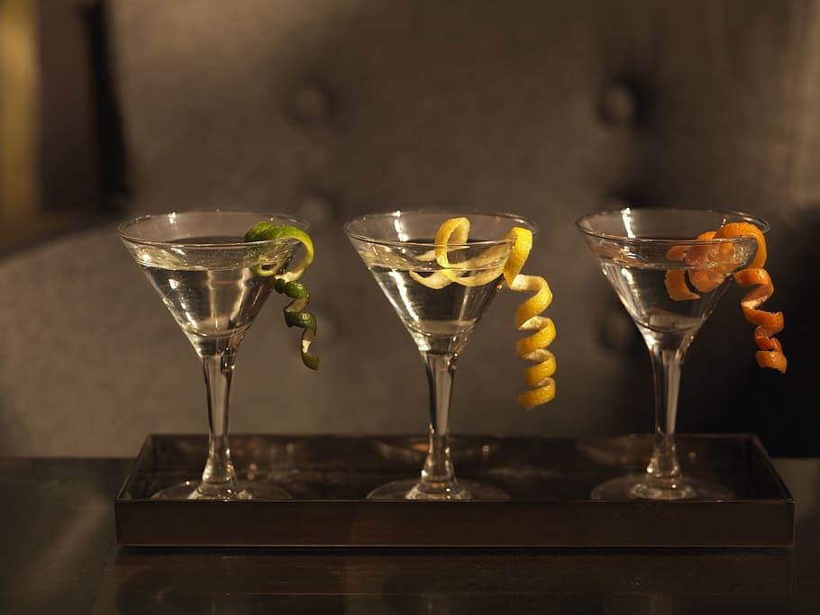 three martini glasses with white liquid and fruit peel garnishing HD wallpaper