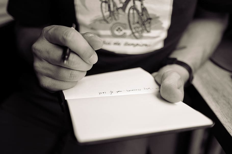 person holding pen and notebook, writing, hand, notes, fingers HD wallpaper
