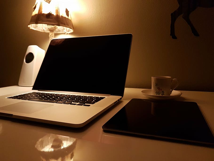 MacBook Pro near ceramic teacup, open, mode, brown, table, laptop