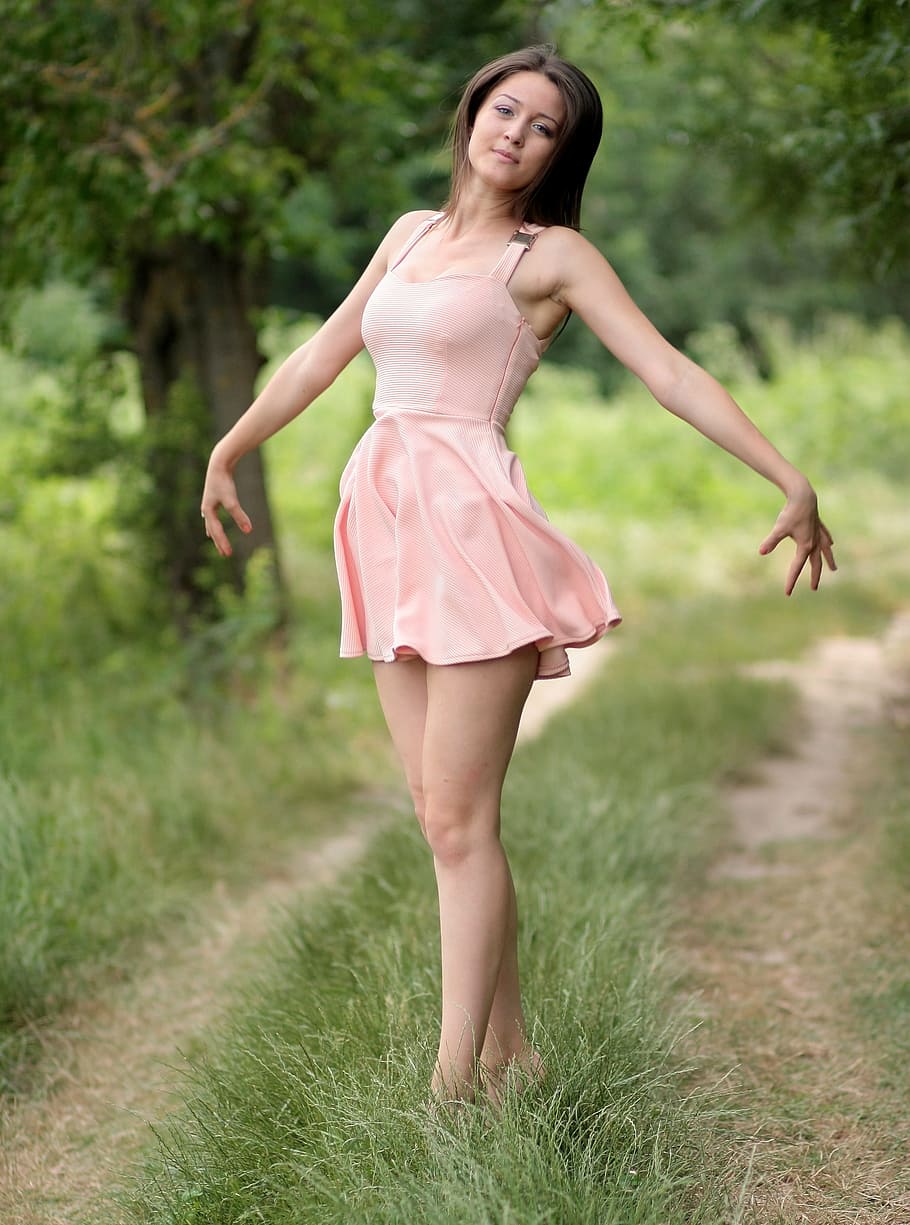woman wearing pink sleeveless mini dress standing on green grass, HD wallpaper