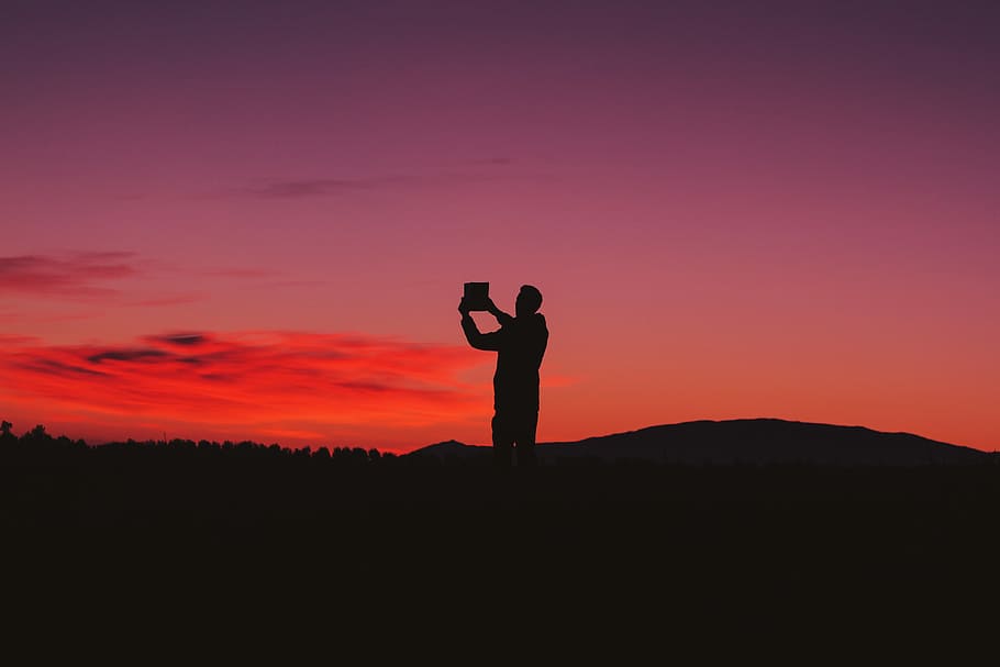 silhouette photo of man on hill, silhouette of person standing on mountain under red sky HD wallpaper