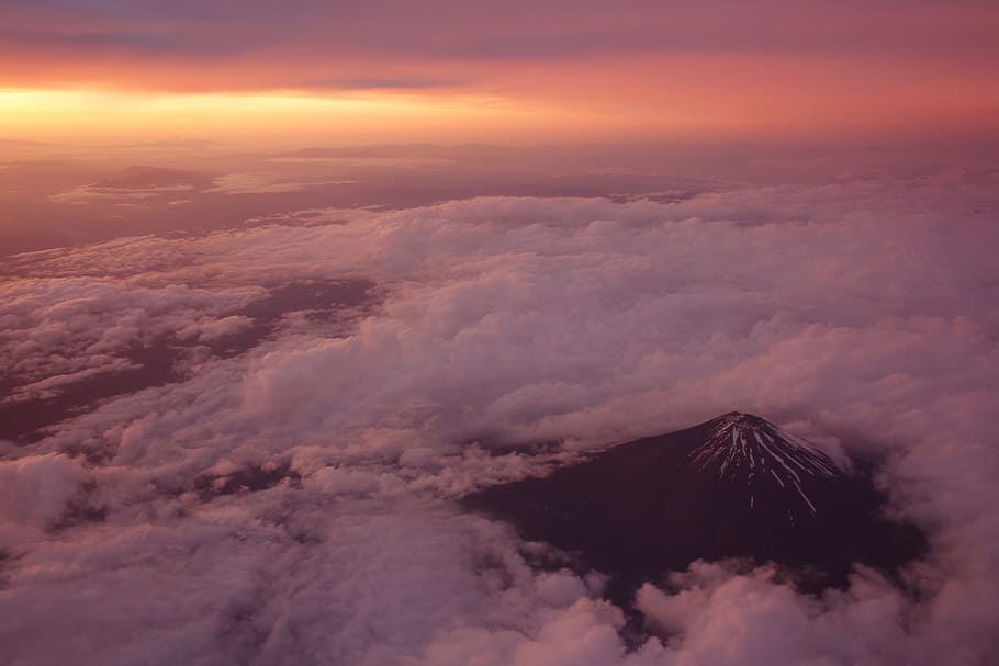 black mountain surrounded with clouds at golden hour, white clouds scenery HD wallpaper