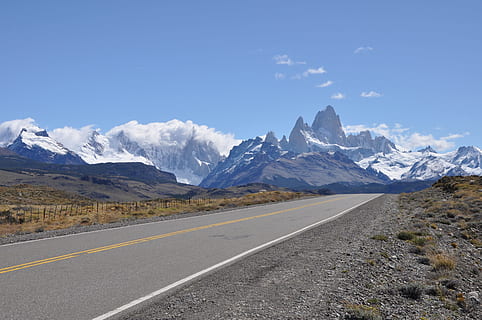 gray concrete road top near snow covered mountain at daytime HD wallpaper
