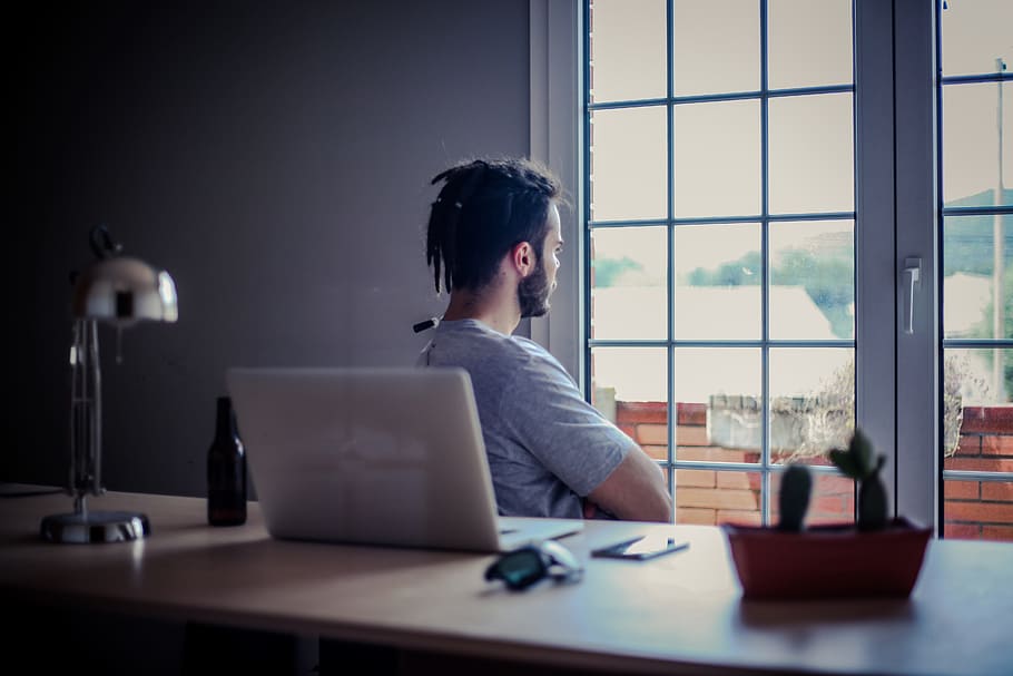 man wearing grey shirt sitting on chair front of window, people HD wallpaper