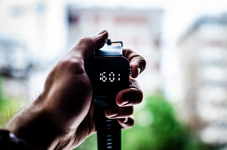 selective focus photography of person holding smartwatch, time HD wallpaper