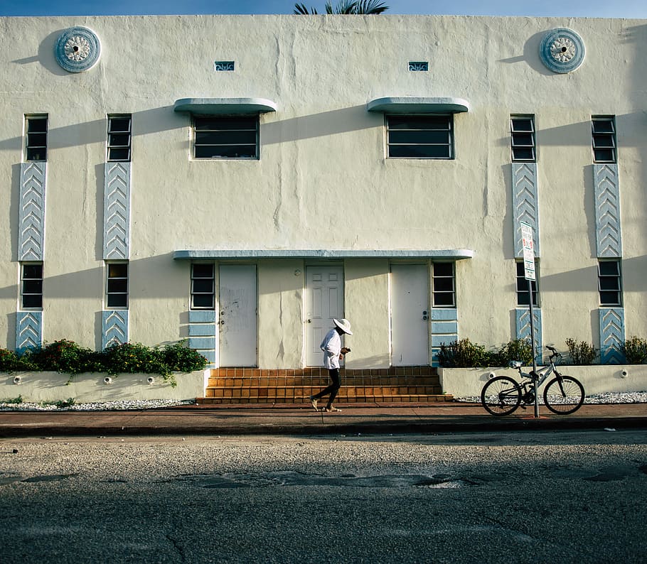 BARE FOOT RUNNING, person walking along the pavement in front of white concrete building HD wallpaper