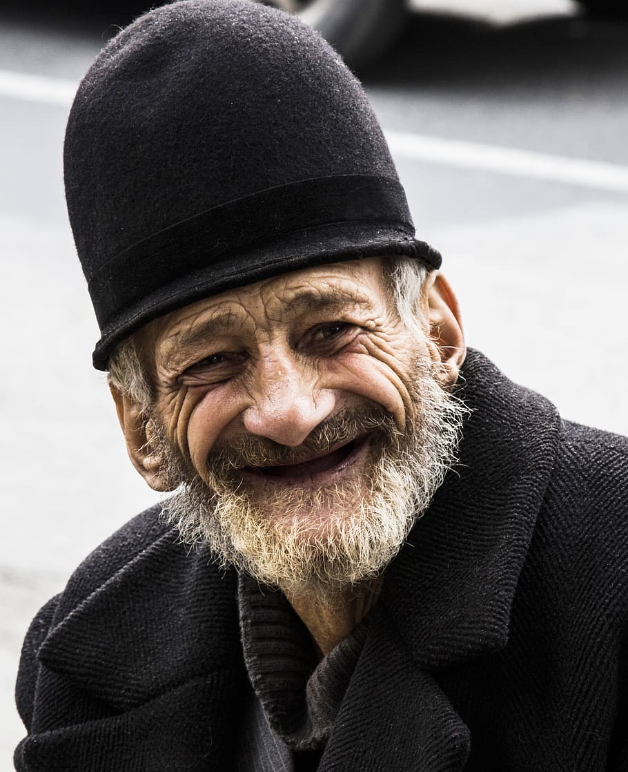 man wearing black coat and hat, old man, portrait, male, happy.