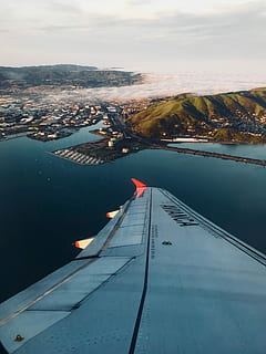 view of island on plane window, airplane wing at daytime, looking down HD wallpaper