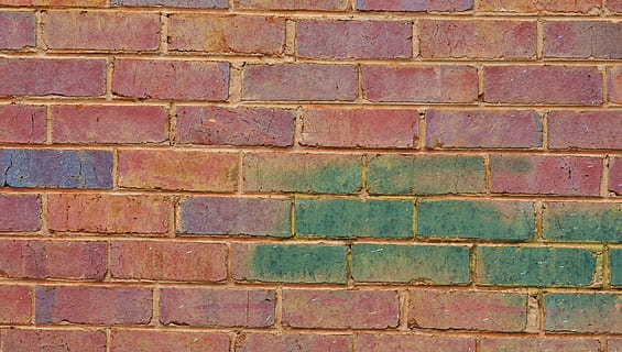 red concrete brick wall with green and purple paint, tinted HD wallpaper