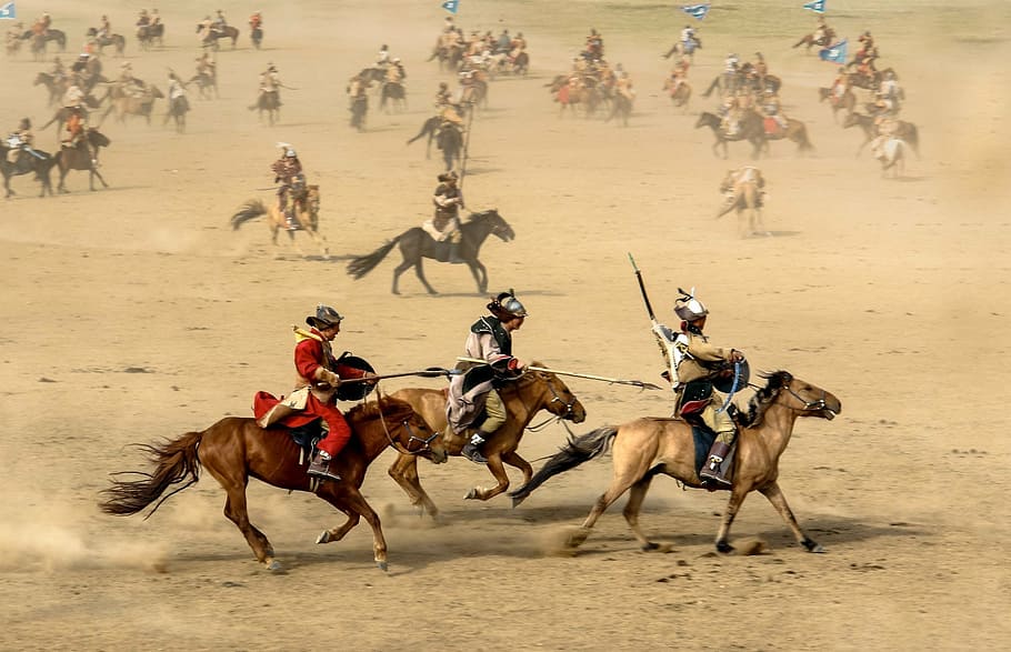 group of people riding horses in sandy area, mongolia, warrior