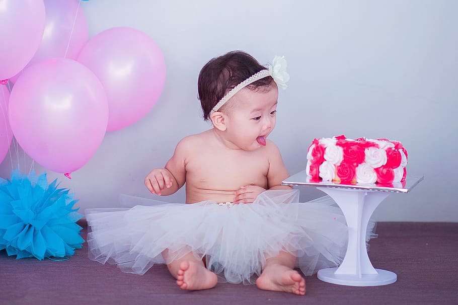 baby in white tutu skirt near white and red fondant cake and pink balloons, HD wallpaper