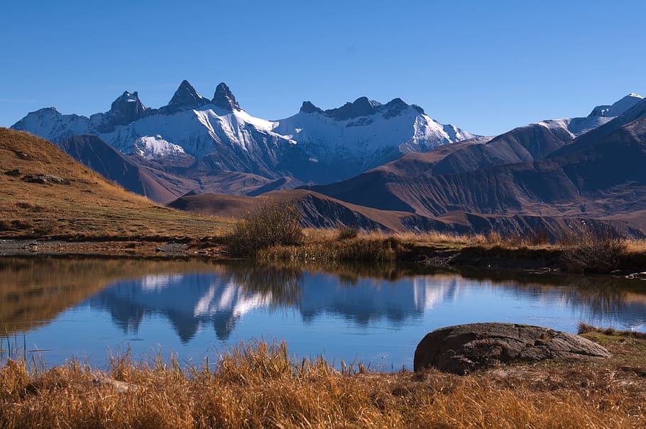 mountain, highland, grass, landscape, nature, lake, water, reflection HD wallpaper