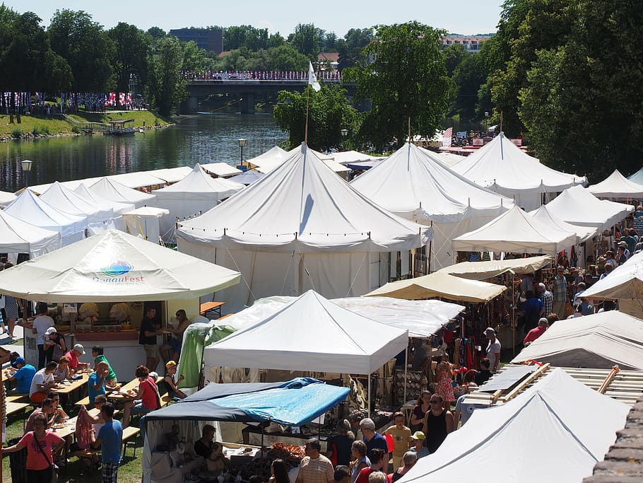 white canopy tents on field with crowd of people during daytime HD wallpaper
