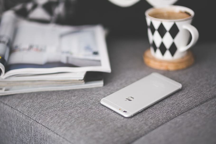 Close of phone on a grey couch, apple, coffee, communication HD wallpaper