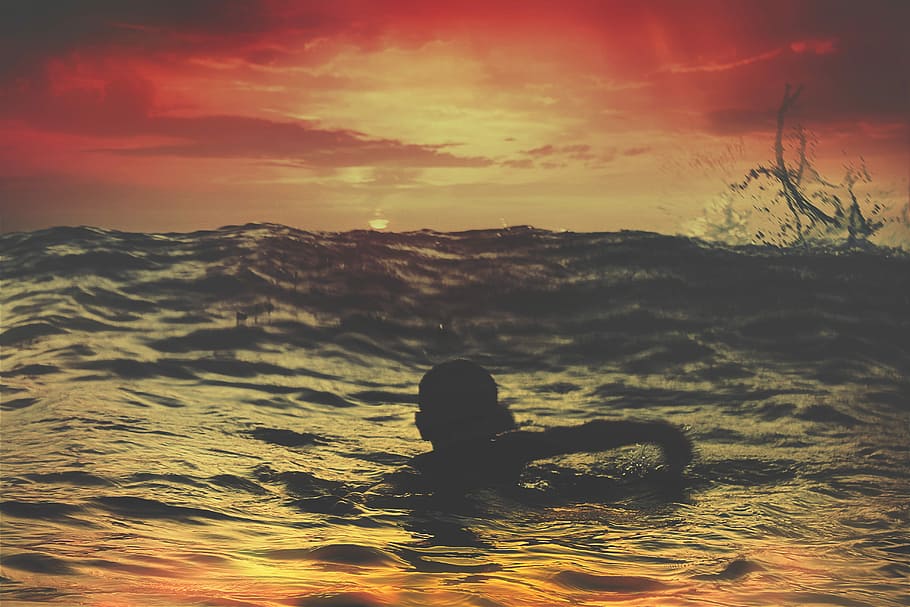 person swimming on body of water under red and orange sky, silhouette of woman swimming on water HD wallpaper