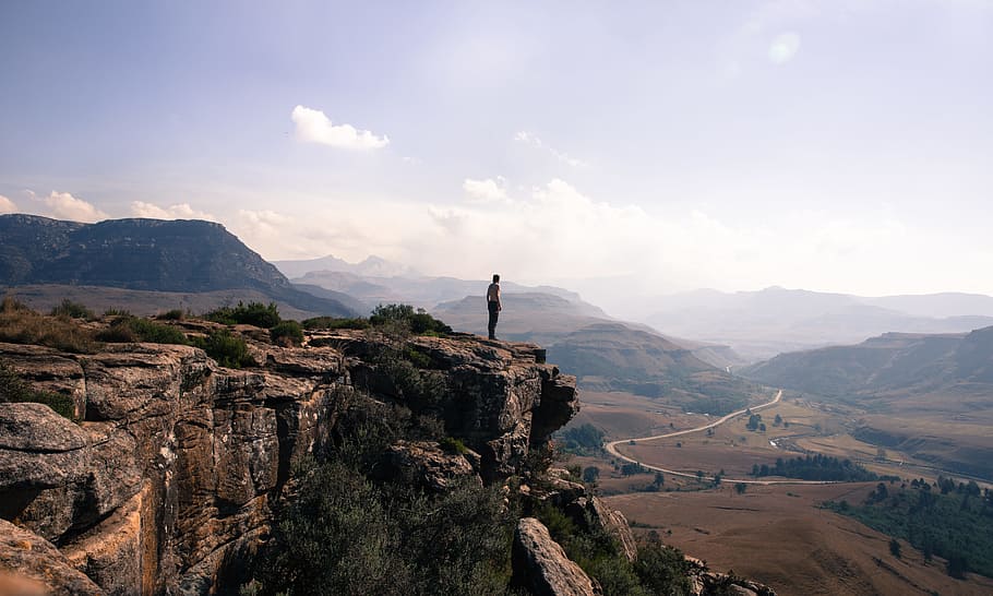 photo of man on top of mountain during daytime, landscape photography of man standing at the cliff HD wallpaper