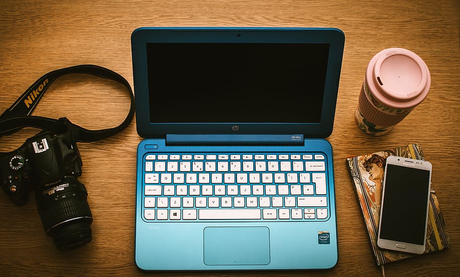 Blue Hp Netbook Beside Black Nikon Dslr Camera and White Samsung Smartphone on Book, HD wallpaper