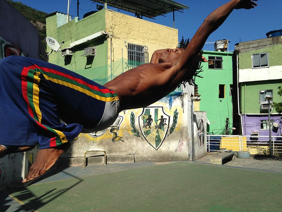 man doing back flip, dance, capoeira, favela, performance, brazil