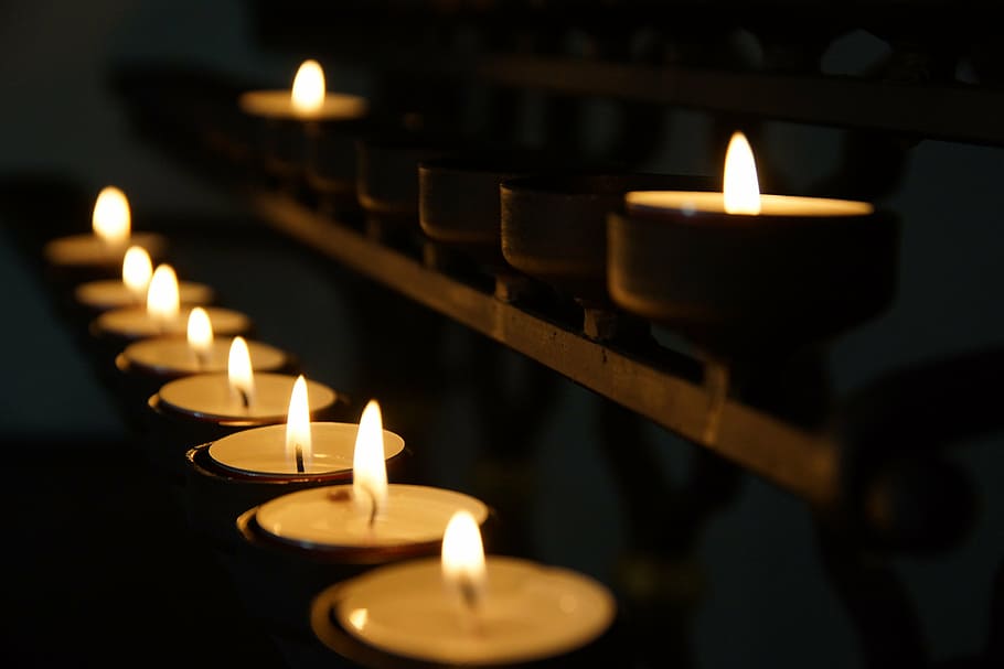 lighted tealight candle on black metal rack, church, candles HD wallpaper